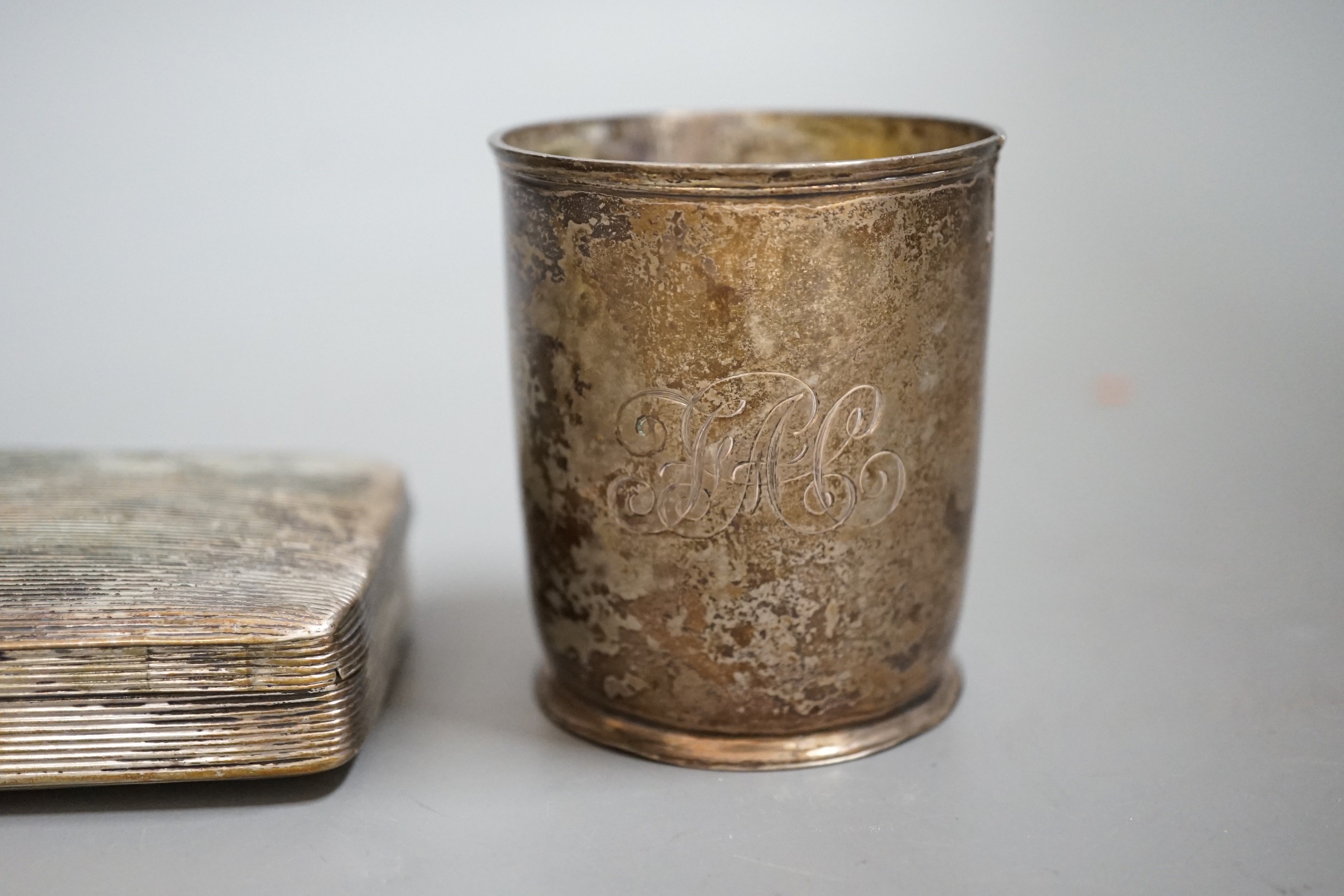 A Dutch white metal tobacco box, 11.3cm and a similar beaker (both a.f.) together with a French engine turned white metal circular compact.